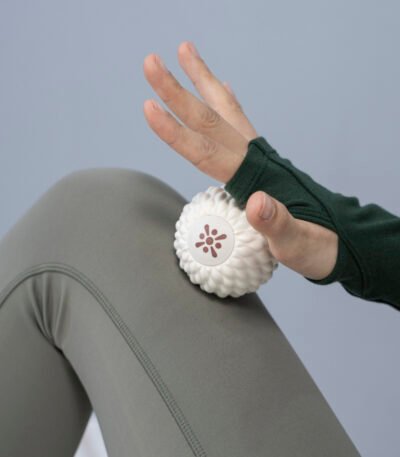 Bloom white massage ball under a hand