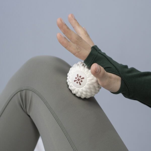 Bloom white massage ball under a hand