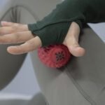 Bloom red ball under a hand